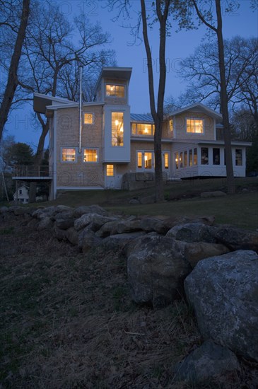 Contemporary shingle style home at dusk