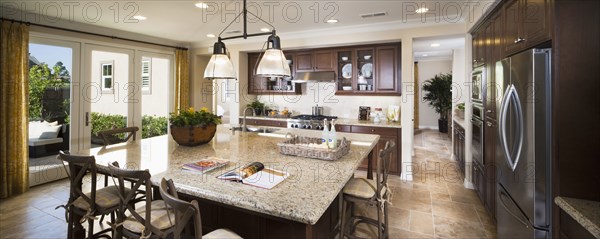 Pendant lights hanging above breakfast bar in traditional American home