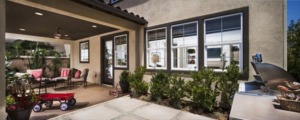 Back patio behind traditional American home