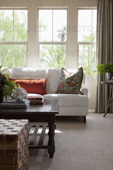 Couch with coffee table against window in the living room at home