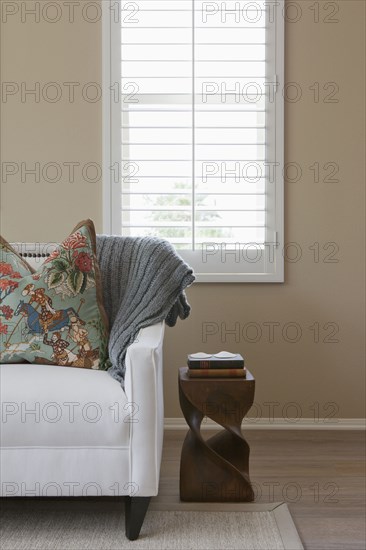 Cropped couch against window in the living room at home