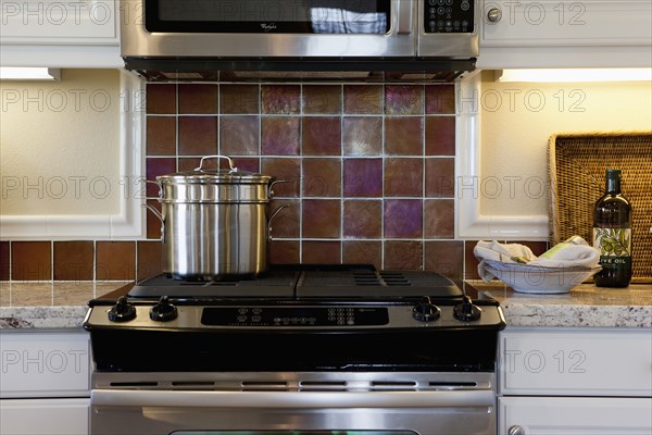 Close-up of utensil on stove in kitchen at home