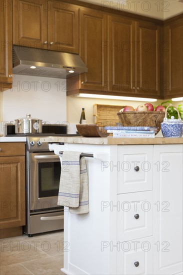 Kitchen with brown cabinets and island at home