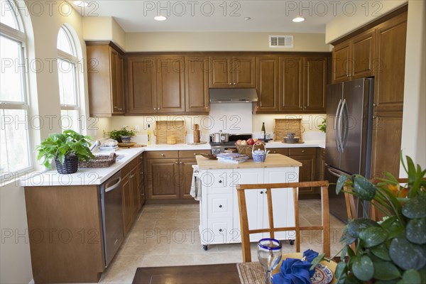 Contemporary kitchen with brown cabinets and island at home