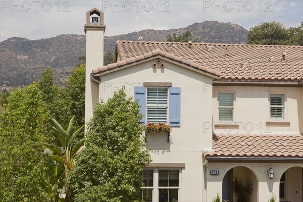 Exterior shot of a residential structure with trees and mountain