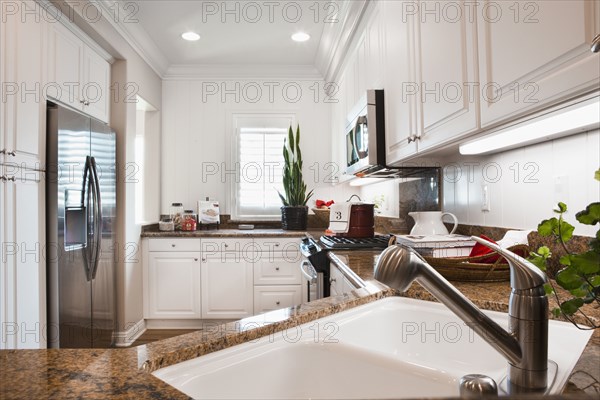 View of a kitchen having white cabinets at home