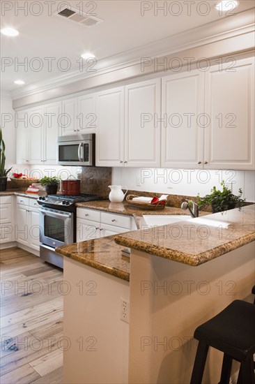 View of a kitchen having white cabinets at home