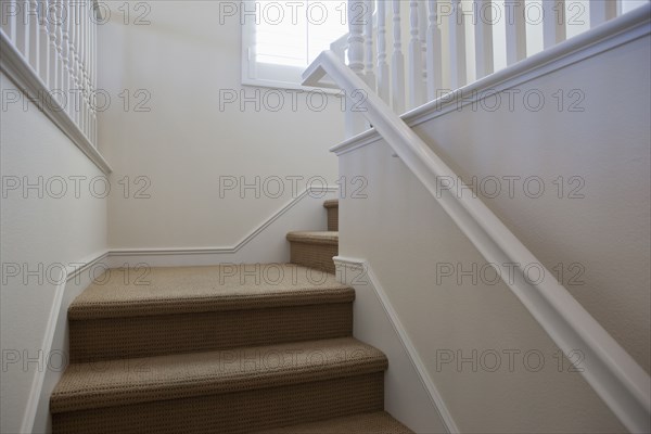 Close-up of stairs with white walls at home