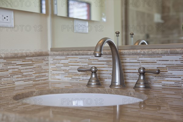 Contemporary bathroom with washbasin and mirror at home