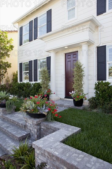 Plants in front of a house with closed door