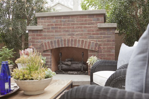 View of sitting area with fireplace and plants at a patio