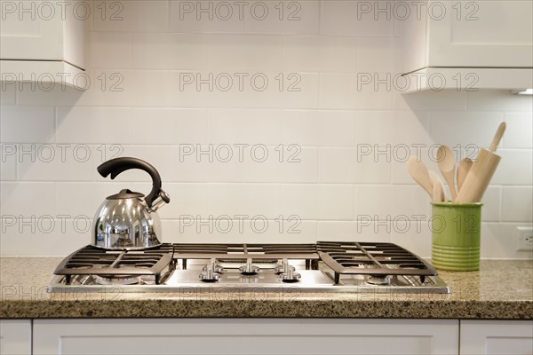 Close-up of a kettle on stove in the kitchen at home