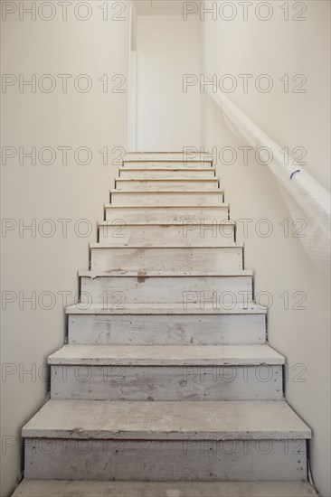 Close-up of white stairs with wall at home