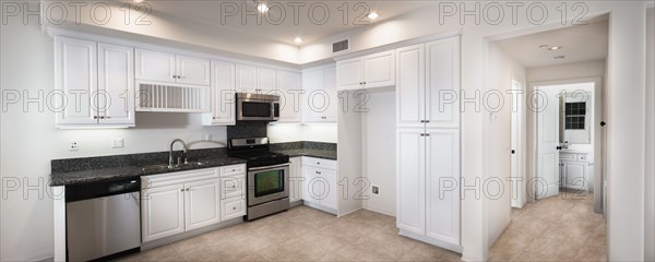 View of a kitchen having white cabinets at home