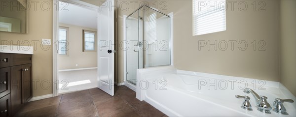 Contemporary bathroom with bath and glass shower at home