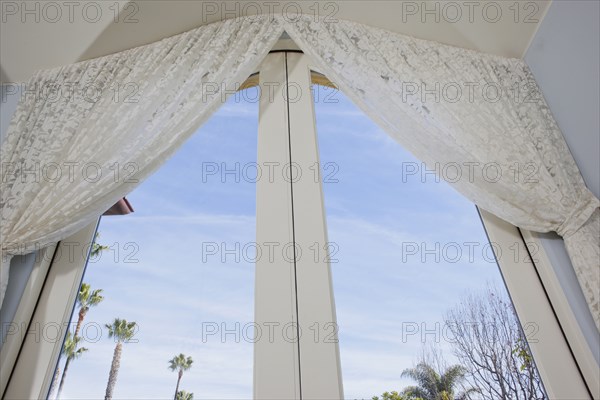 Low angle view of curtain on glass door at home