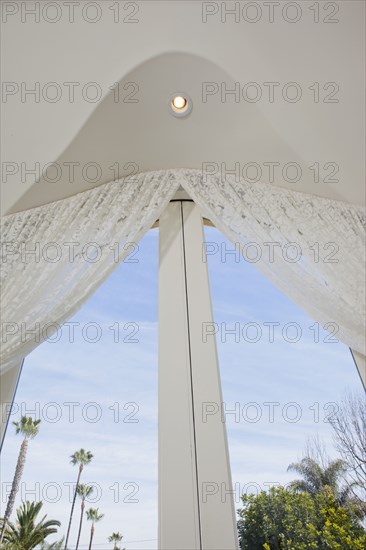 Low angle view of curtain on glass door at home