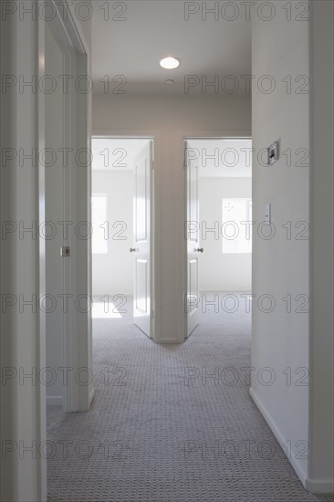 Empty room with open doors and hallway at home