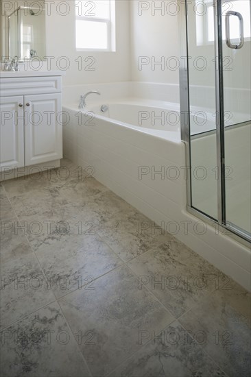 Bathroom with bath and cabinets at home