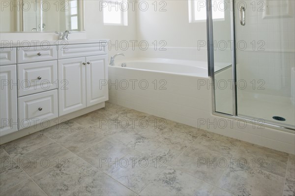 Bathroom with bath and cabinets at home