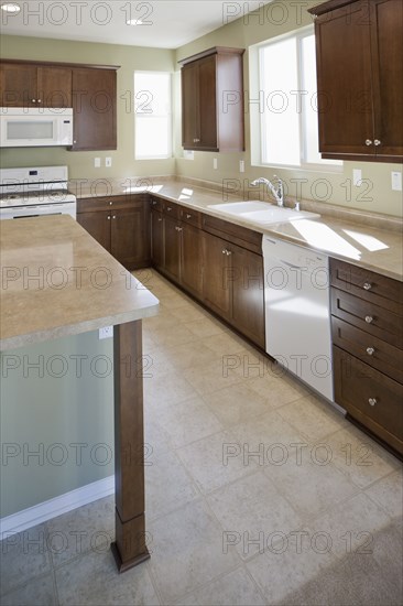 Kitchen having brown cabinets and island at home