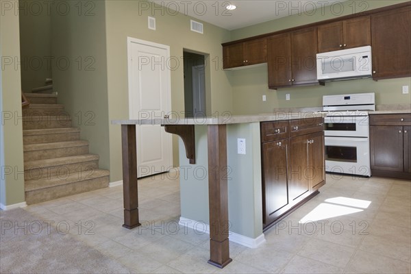 Kitchen having brown cabinets and island at home