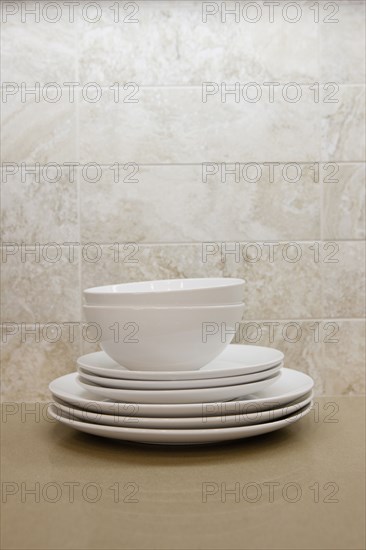 Close-up of bowls with plates in the shelf