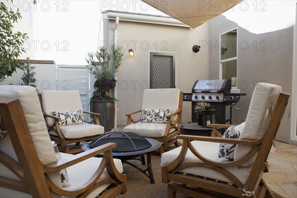 View of sitting area with barbecue at a patio