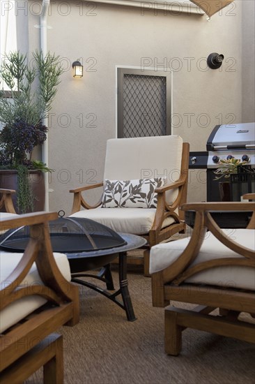 View of sitting area with barbecue at a patio