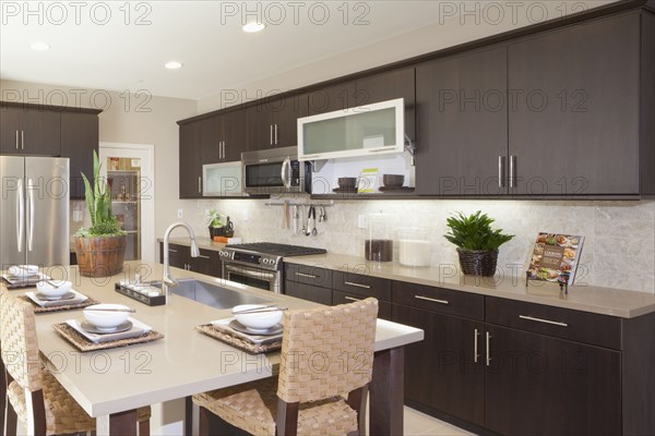 Kitchen having brown cabinets and island at home