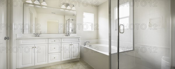 Bathroom with bath and cabinets at home
