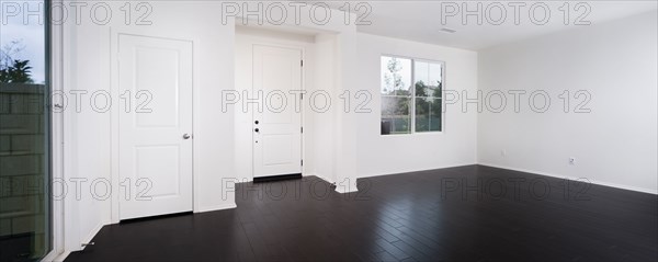 Empty room with window and closed doors