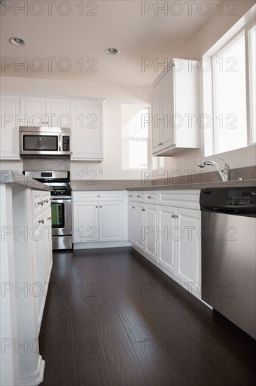 View of a kitchen having white cabinets at home