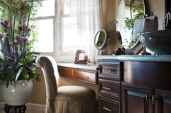 Chair at dressing table in bathroom at home