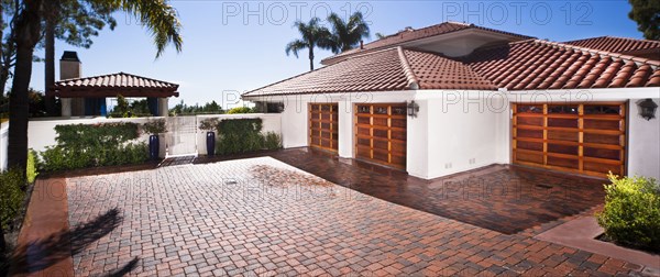 Exterior shot of closed garages with brick flooring