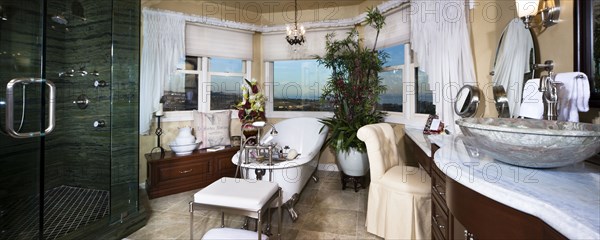 Contemporary bathroom with bath and glass shower at home