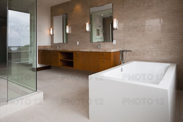 Contemporary bathroom with bath and glass shower at home