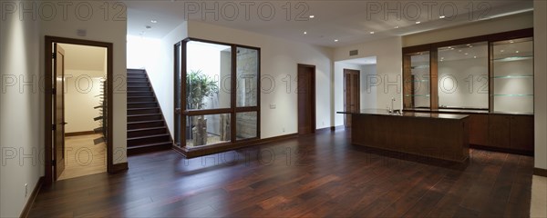 Empty house with kitchen area and wooden floor