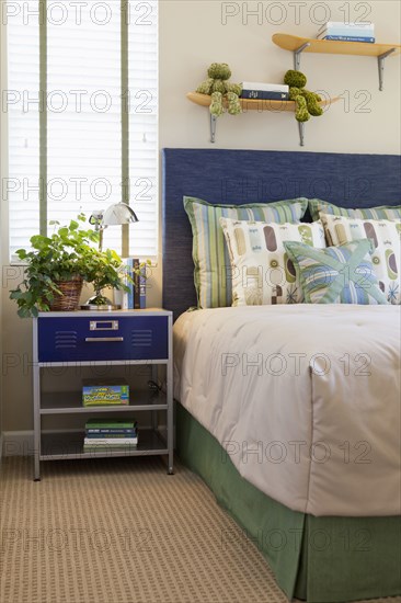 Arranged pillows on tidy bed in the bedroom at home