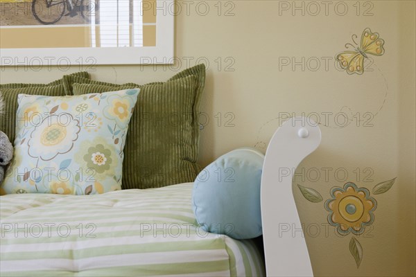 Close-up of cropped couch against designed wall at home