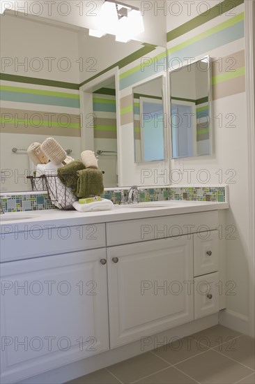 Bathroom with washbasin at mirror in the house