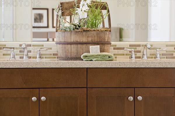 Close-up of taps with brown cabinets at home