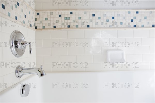 Close-up of shower taps in bathroom at home