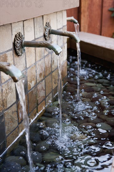 Water flowing from fountains outside house