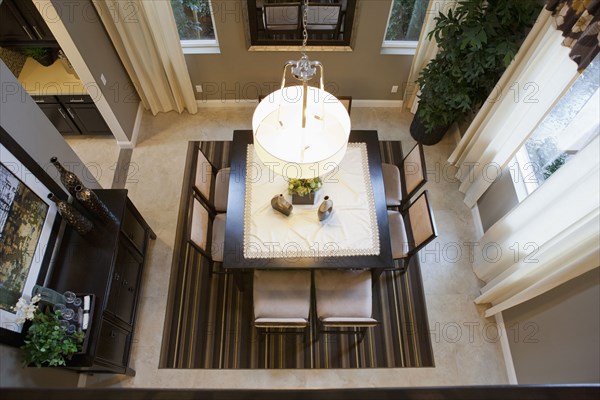 High angle view of pendant light hanging over dining table at home