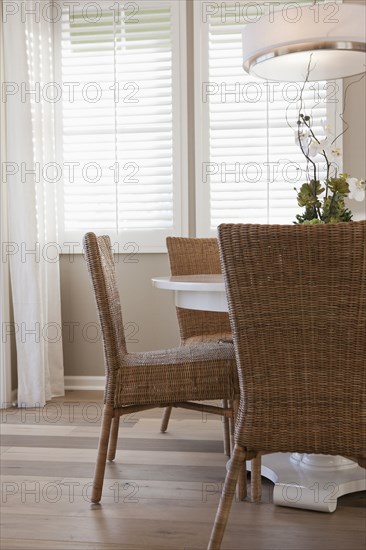 Wicker chairs at dining table in middle class house