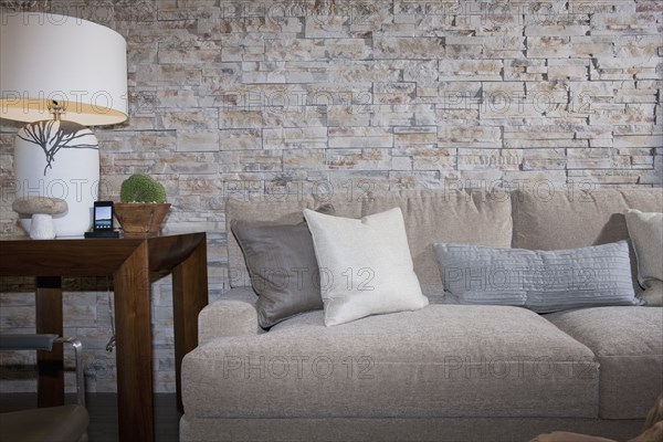 End table and sofa against slate wall