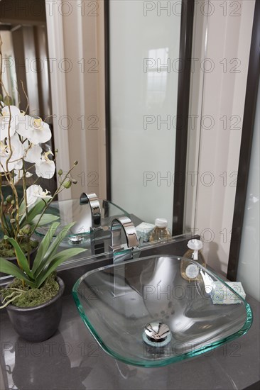 Glass sink and mirror in bathroom