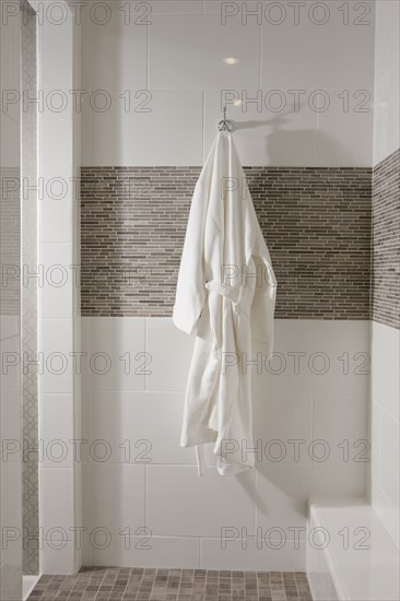 White bathrobe hanging in bathroom