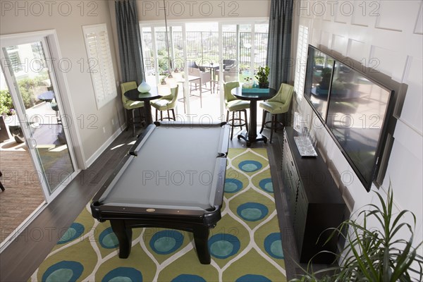 High angle view of pool table and televisions in games room